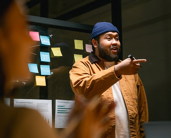 An asian man facilitating an engaging workshop.