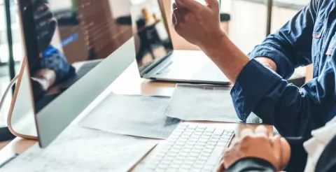 A cybersecurity expert points at code on a monitor