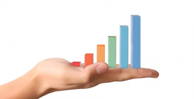 A hand holds colorful bar graphs, symbolizing how descriptive analytics brings quantitative insights and clear visualization from raw data.