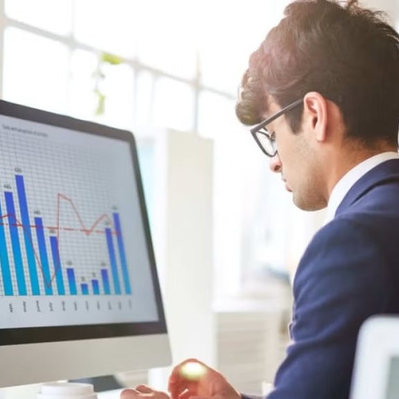 A fintech expert working at his computer